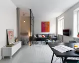 Ljus och modern lägenhet med avdelat sovrum bakom glasvägg. Perfekt kattvind inspiration för små utrymmen.