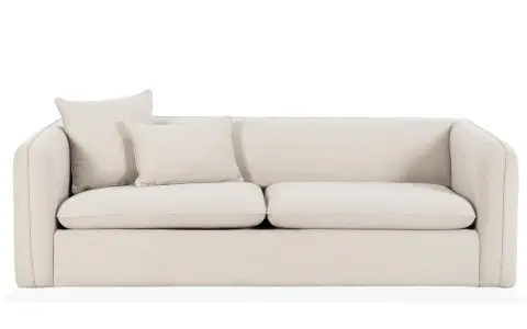 En ljusbeige bäddsoffa med två kuddar. Perfekt för gäster eller en mysig kväll.