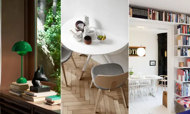 En grön lampa på en bokhög, ett runt bord med porslin och en inreda bokhylla snyggt fylld med böcker.